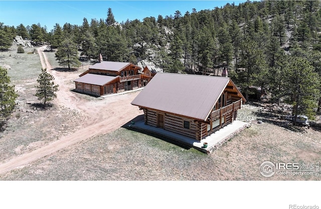 view of subject property with a forest