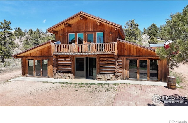back of property with stone siding