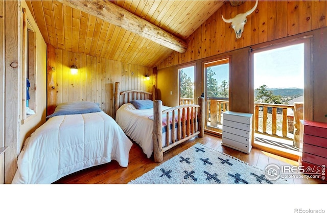 bedroom with hardwood / wood-style floors, wood walls, access to exterior, and wood ceiling