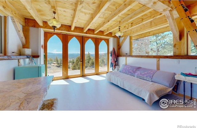 bedroom with multiple windows, beamed ceiling, wood ceiling, and access to outside