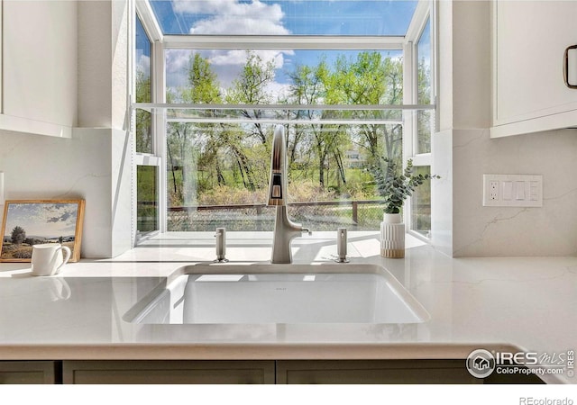 536 W Sycamore Cir, Louisville, CO 80027 - kitchen view of a sink, light countertops, and white cabinets