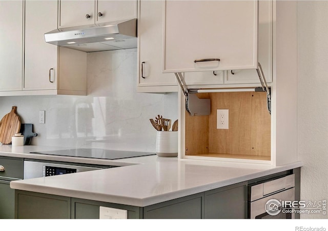 536 W Sycamore Cir, Louisville, CO 80027 - kitchen with under cabinet range hood, black electric stovetop, light countertops, decorative backsplash, and gray cabinets