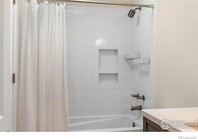 536 W Sycamore Cir, Louisville, CO 80027 - bathroom with shower / bath combo, a textured wall, and vanity