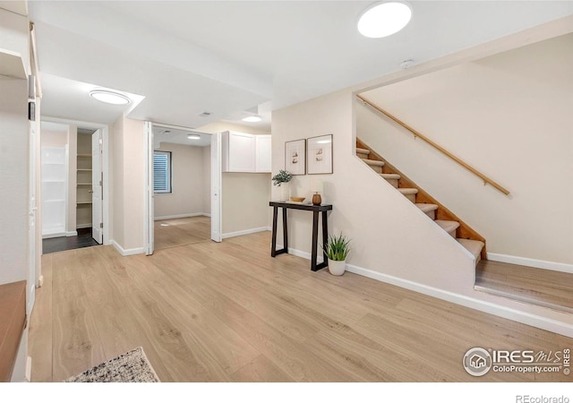 536 W Sycamore Cir, Louisville, CO 80027 - below grade area with light wood-type flooring, baseboards, and stairway