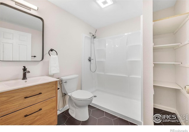 536 W Sycamore Cir, Louisville, CO 80027 - full bath with tile patterned floors, a shower, toilet, vanity, and baseboards