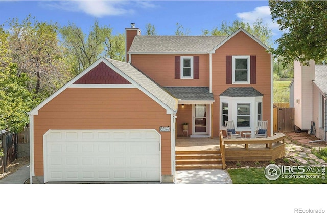 536 W Sycamore Cir, Louisville, CO 80027 - view of front of property with fence, a chimney, a shingled roof, a garage, and a wooden deck
