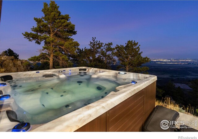 9360 Gold Mine Rd, Loveland, CO 80538 - pool at dusk with a hot tub