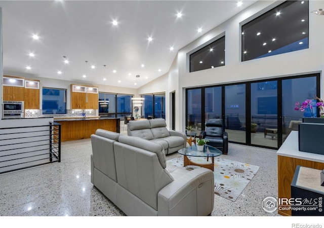 9360 Gold Mine Rd, Loveland, CO 80538 - living room with dark speckled floor, high vaulted ceiling, and recessed lighting