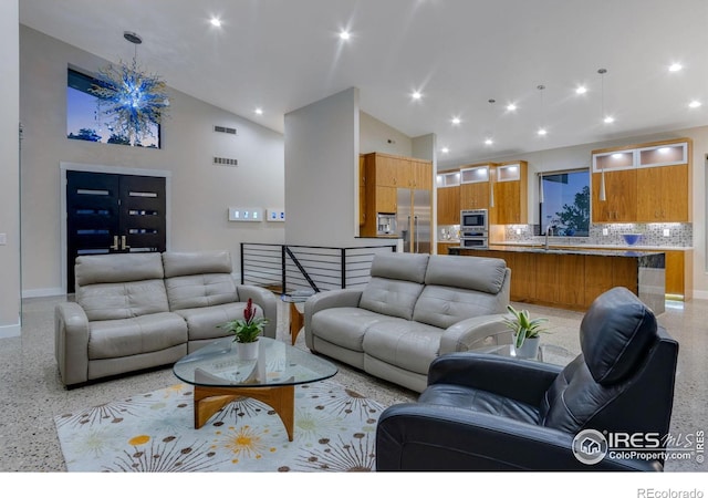 9360 Gold Mine Rd, Loveland, CO 80538 - living area featuring dark speckled floor, baseboards, high vaulted ceiling, and recessed lighting