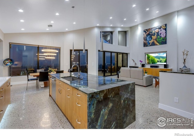 9360 Gold Mine Rd, Loveland, CO 80538 - kitchen featuring dark aggregate flooring, modern cabinets, a sink, dark stone counters, and a chandelier