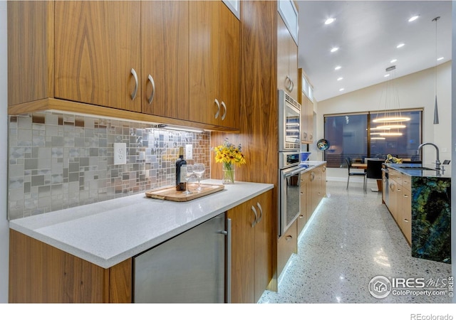 9360 Gold Mine Rd, Loveland, CO 80538 - kitchen featuring modern cabinets, oven, brown cabinets, and vaulted ceiling