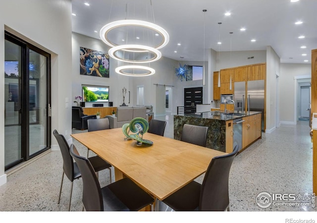 9360 Gold Mine Rd, Loveland, CO 80538 - dining room with dark aggregate flooring, a towering ceiling, baseboards, and recessed lighting