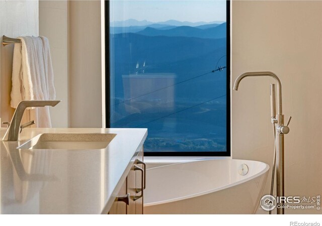 9360 Gold Mine Rd, Loveland, CO 80538 - full bath featuring a mountain view, a soaking tub, and vanity
