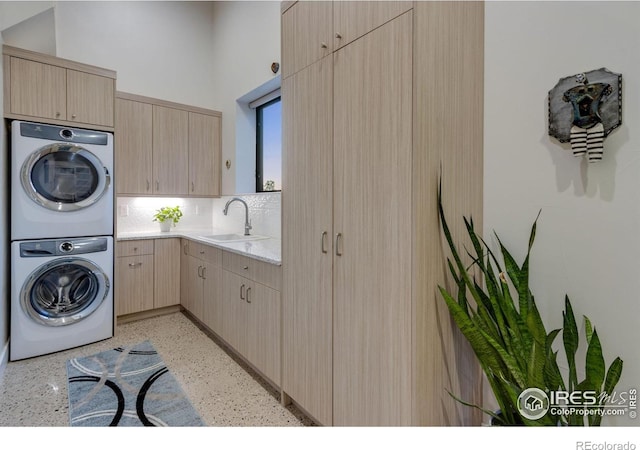9360 Gold Mine Rd, Loveland, CO 80538 - laundry area with estacked washer and dryer and cabinet space