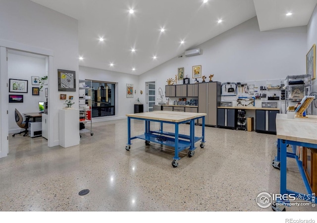 9360 Gold Mine Rd, Loveland, CO 80538 - playroom with dark aggregate flooring, an office area, high vaulted ceiling, an AC wall unit, and baseboards