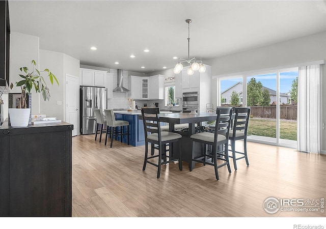 dining space featuring light wood-type flooring and recessed lighting