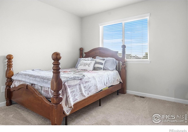 bedroom with baseboards and carpet flooring