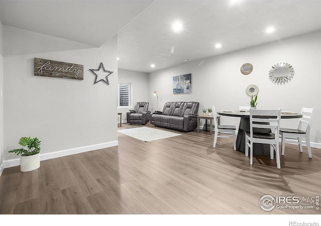 living room featuring wood finished floors, recessed lighting, and baseboards