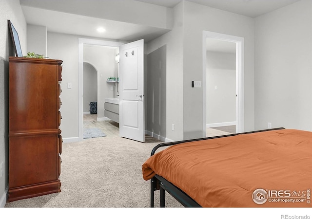 bedroom featuring carpet floors, arched walkways, recessed lighting, and baseboards