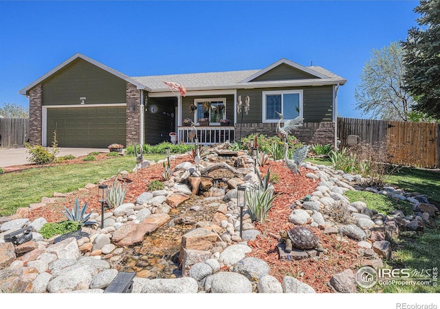 view of front of property with fence, a garage, concrete driveway, and covered porch
