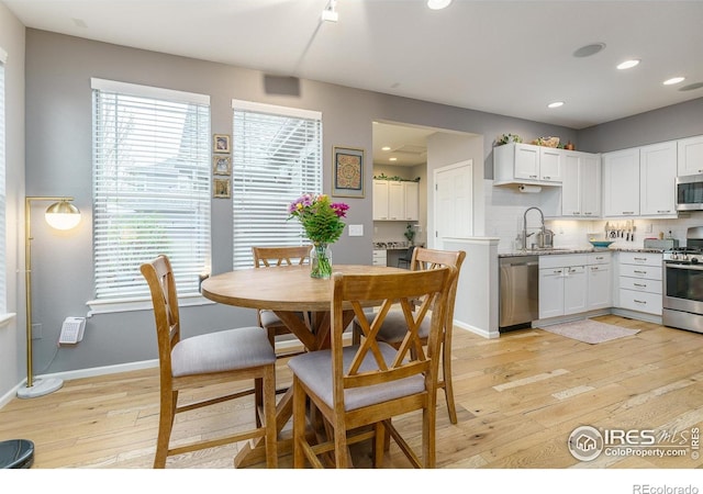 1675 Saratoga Dr, Lafayette, CO 80026 - dining space with light wood finished floors, plenty of natural light, and recessed lighting