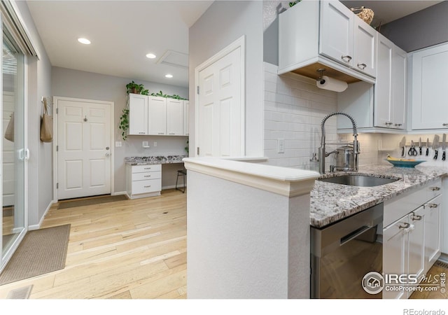1675 Saratoga Dr, Lafayette, CO 80026 - kitchen with dishwasher, light wood-style flooring, decorative backsplash, white cabinets, and light stone countertops
