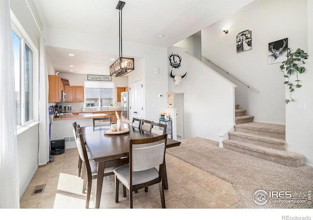 7235 Andover St, Wellington, CO 80549 - dining space featuring stairs, a chandelier, recessed lighting, and baseboards