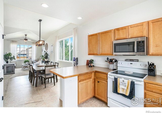 7235 Andover St, Wellington, CO 80549 - kitchen featuring stainless steel microwave, electric stove, a peninsula, ceiling fan, and light countertops