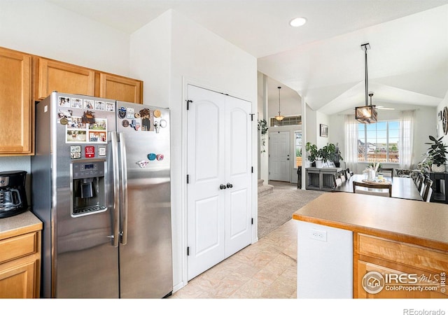7235 Andover St, Wellington, CO 80549 - kitchen with stainless steel fridge, open floor plan, recessed lighting, light countertops, and lofted ceiling
