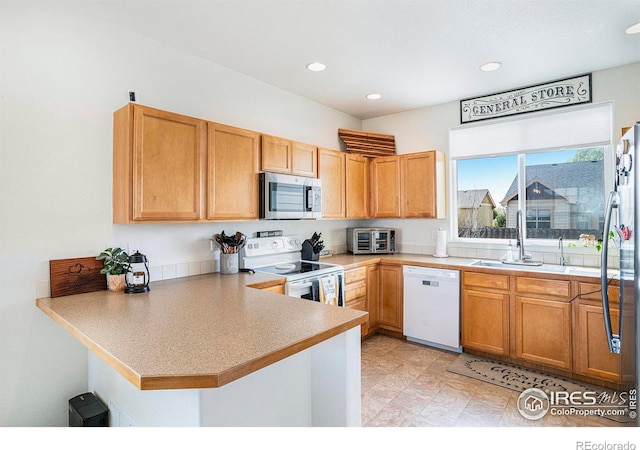 7235 Andover St, Wellington, CO 80549 - kitchen with stainless steel appliances, a sink, a peninsula, recessed lighting, and light countertops