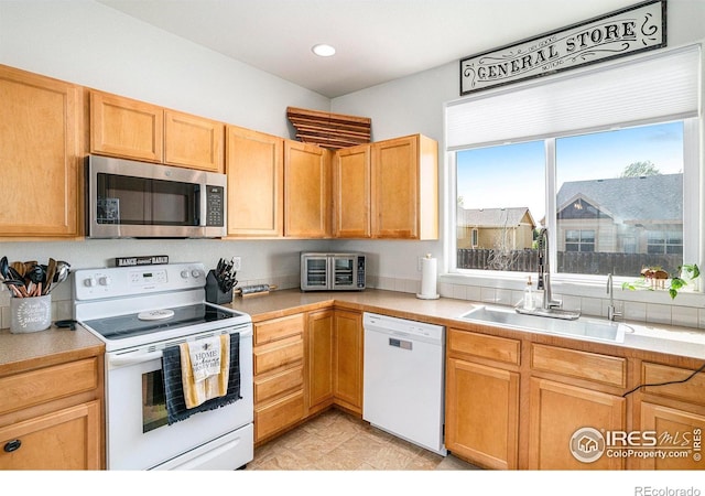 7235 Andover St, Wellington, CO 80549 - kitchen with white appliances, a sink, light countertops, and recessed lighting