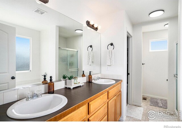 7235 Andover St, Wellington, CO 80549 - bathroom featuring a stall shower and double vanity