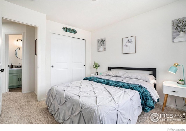7235 Andover St, Wellington, CO 80549 - bedroom featuring carpet floors, a closet, baseboards, connected bathroom, and a sink
