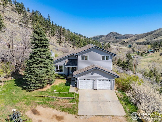 tri-level home with driveway and a mountain view
