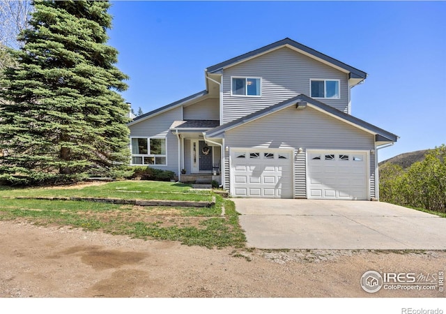 traditional home featuring concrete driveway and a garage