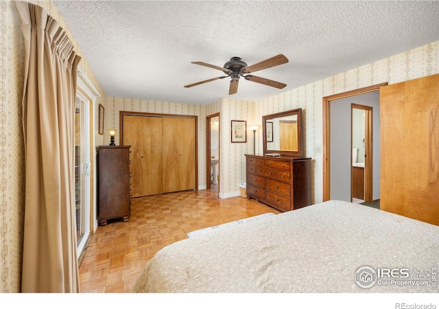 bedroom featuring wallpapered walls, a textured ceiling, a ceiling fan, and baseboards