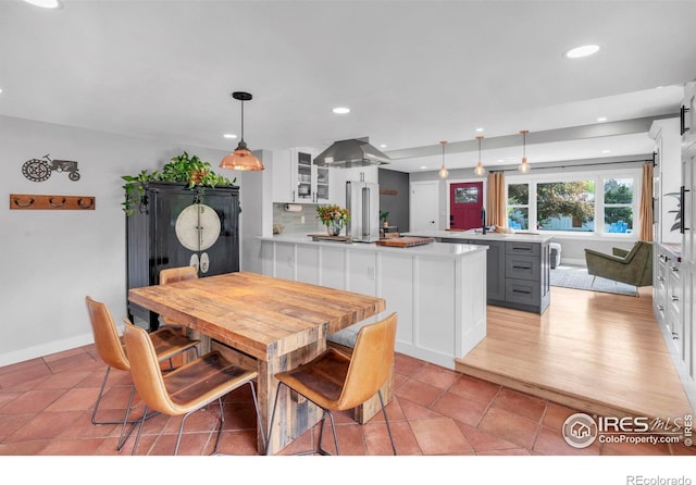 dining room with recessed lighting, baseboards, and light tile patterned floors