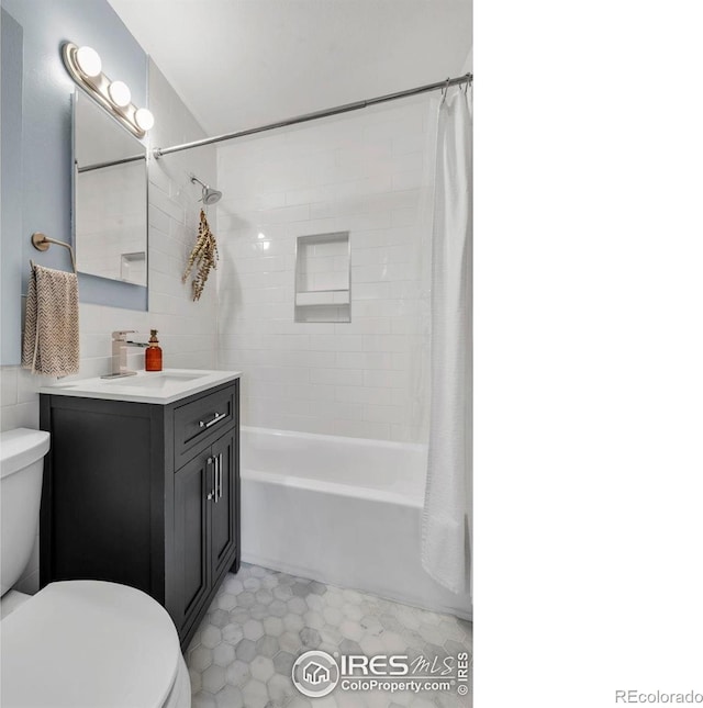 bathroom featuring toilet, shower / tub combo, vanity, and tile walls