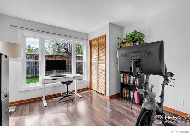 office space with wood finished floors and baseboards