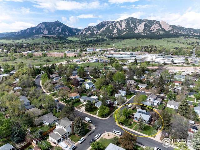 aerial view of property's location with a mountain backdrop and nearby suburban area
