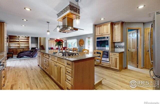 kitchen featuring stainless steel appliances, open floor plan, light wood-style flooring, island range hood, and recessed lighting