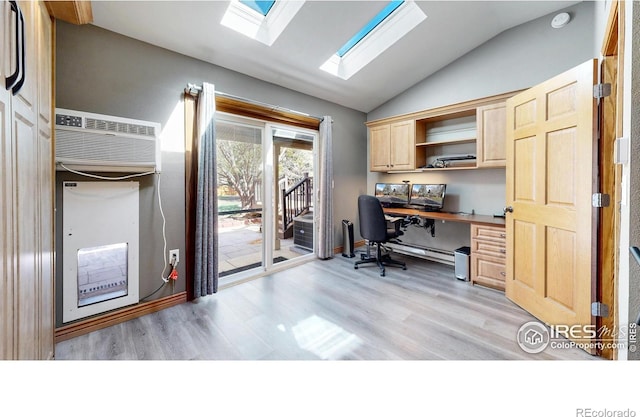 office featuring lofted ceiling, light wood finished floors, built in study area, a skylight, and a wall mounted AC