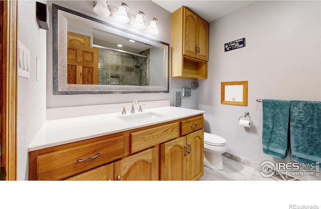 full bathroom featuring a shower stall, toilet, vanity, tile patterned flooring, and baseboards