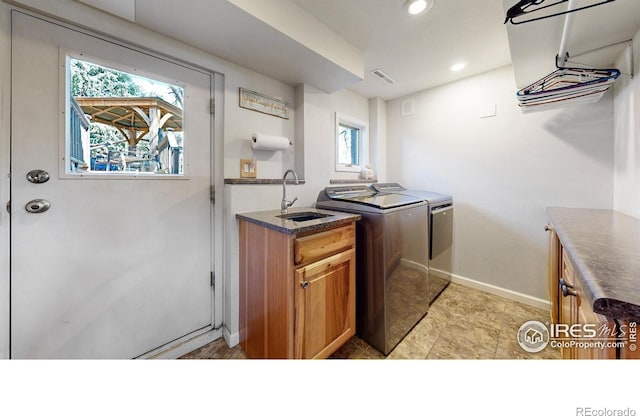 laundry room featuring independent washer and dryer, cabinet space, baseboards, and recessed lighting