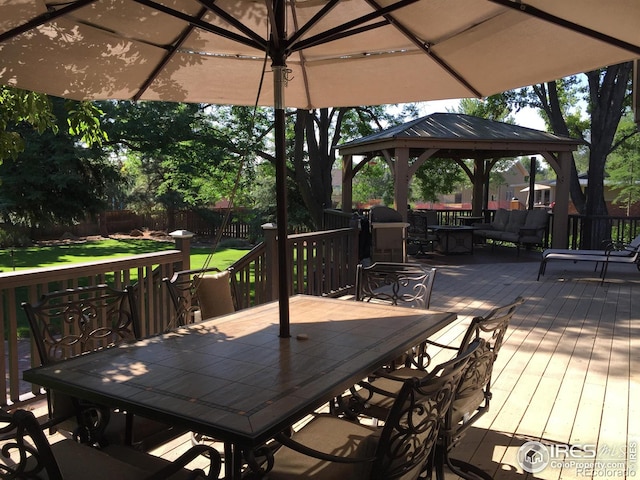 deck featuring a gazebo and outdoor dining space