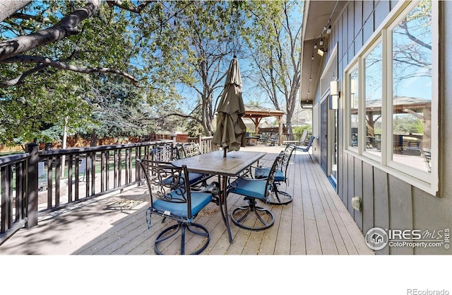 wooden deck with outdoor dining space