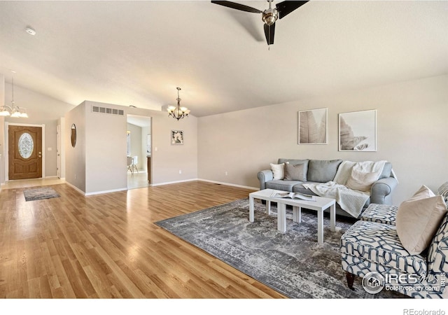 living room with a chandelier, light wood-style flooring, baseboards, lofted ceiling, and a ceiling fan