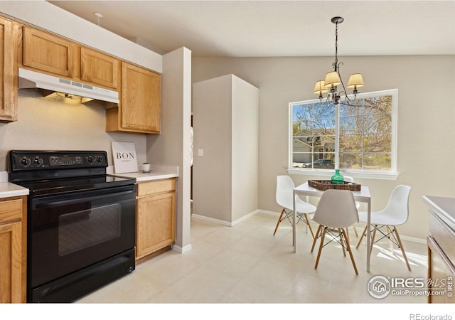 kitchen with black range with electric cooktop, under cabinet range hood, baseboards, a chandelier, and light countertops