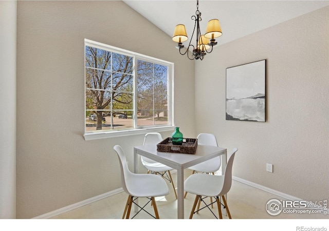 dining room featuring a chandelier and baseboards
