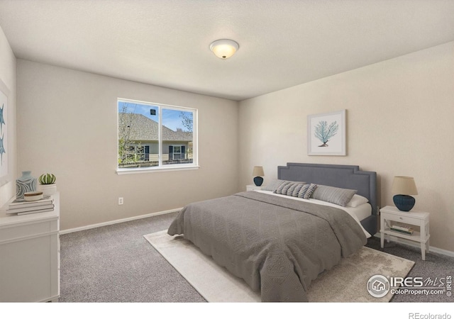 bedroom featuring carpet and baseboards